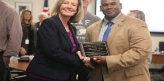 Amanda Ellis, chief academic officer and deputy commissioner for the Kentucky Department of Education, receives the Kevin Noland/Mary Ann Miller Award from Education Commissioner Wayne Lewis at the Kentucky Board of Education's Dec. 5 meeting. The award recognizes a KDE employee for significant service to Kentucky's public schools and for providing inspiration for education. Photo by Megan Gross, Dec. 5, 2018