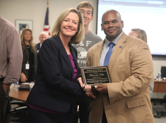 Amanda Ellis, chief academic officer and deputy commissioner for the Kentucky Department of Education., receives the Kevin Nolan/Mary Ann Miller Award from Education Commissioner Wayne Lewis at the Kentucky Board of Education's Dec. 5 meeting. The award recognizes a KDE employee for significant service to Kentucky's public schools and for providing inspiration for education. Photo by Megan Gross, Dec. 5, 2018