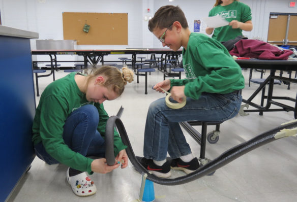 Bullitt Advanced Math and Science students, from left, Kacee Blair, Samuel Wilbert and Olivia First work on their roller coaster track. Each roller coaster was required to have one loop, two hills, one curve and a completed Engineering Design Project (EDP) narrative. Teams could earn bonus points for additional hills, loops and curves. Photo submitted