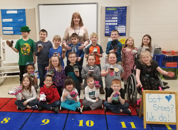 Amanda White poses for a picture with her 1st grade class at Straub Elementary (Mason County). The class is collecting shoes to donate to Haiti. They began with a goal of 25 pairs of shoes and are now at almost 200. Photo submitted by Amanda White