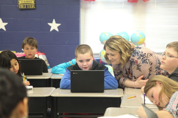 Jessica McPherson, the principal at Gamaliel Elementary School (Monroe County), takes a look at what student Danyel Combs is working on in a social studies class.