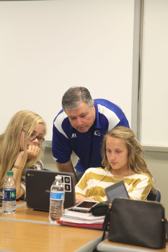 Larry Correll, a computer science teacher at Glasgow High School (Glasgow Independent), works with two students in one of his classes. Photo by Megan Gross, April 8, 2019