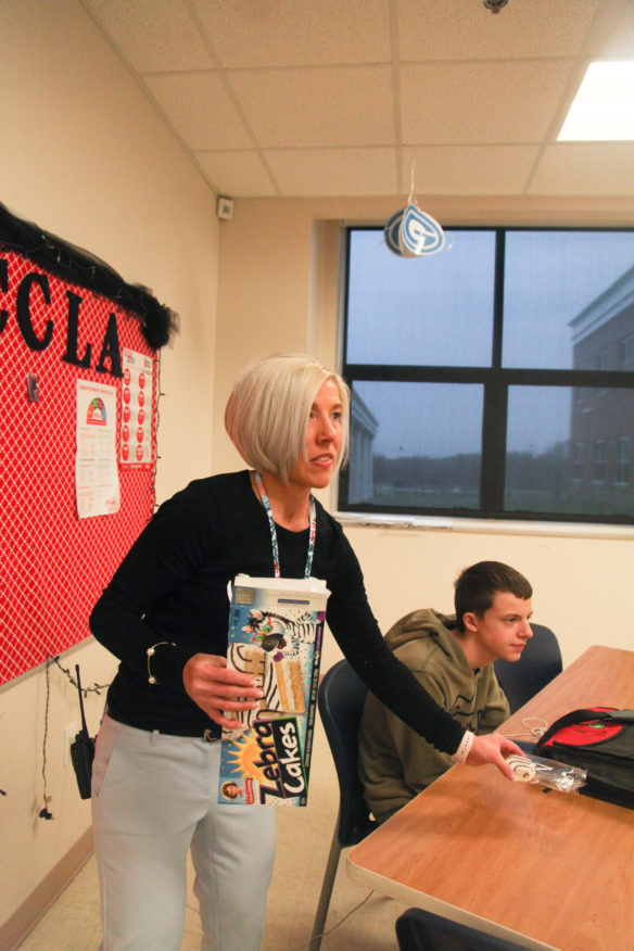 Amy Allen, the principal of Glasgow High School (Glasgow Independent), passes out snack cakes as a reward to students whose class won a motivational “Name That Tune” contest on a Monday morning. Photo by Megan Gross, April 8, 2019