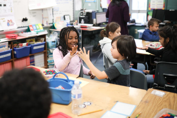 Maxwell Elementary students Kimora Alexander, from left, and Silas Garcia play a game in the their mathematics class.