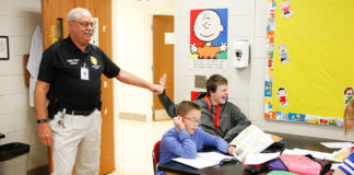 Charles Parker, a member of the Laurel County schools’ Security Response Team, high-fives a student as he drops into a class at South Laurel Middle School. In the future, there may be more school safety people with the passage of Senate Bill 1 during the 2019 Regular Session of the Kentucky Legislature. Known as the School Safety and Resiliency Act, the bill calls for establishing a state school safety marshal, conducting risk assessments, boosting safety and prevention training, requiring superintendents to appoint a school safety coordinator, increasing awareness of suicide prevention efforts, encouraging collaboration with law enforcement, and, as funds become available, hiring more counselors and school resource officers in school districts. Photo by Mike Marsee, Sept. 27, 2018