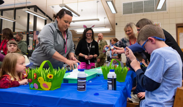 Volunteers and staff from KSB get the shaving cream ready for the students to dye eggs. Photo by Jacob Perkins, April 19, 2019