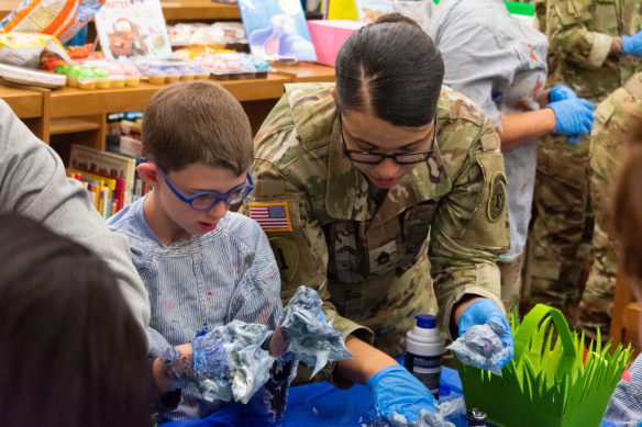 One of the soldiers from the Fort Knox Recruiting Command assists 1st-grader Ethan Buckner with his eggs. Photo by Jacob Perkins, April 19, 2019