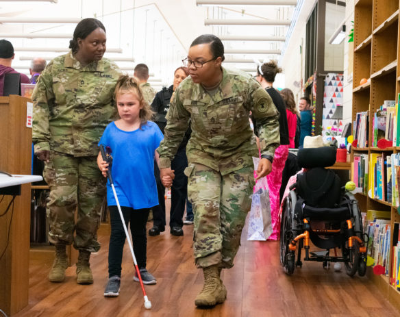 Hailey Hitner, a 2nd-grader at KSB, assisted by soldiers from the Fort Knox Recruiting Command, begins to hunt for accessible Easter eggs. Photo by Jacob Perkins, April 19, 2019