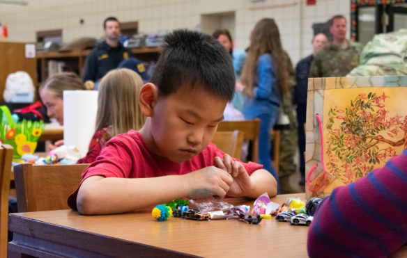 Kai Turpin feels a toy that he received from one of his eggs during the accessible egg hunt at Kentucky School for the Blind. Photo by Jacob Perkins, April 19, 2019