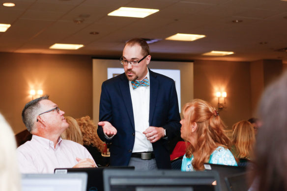 Matthew Courtney, center, an educational recovery consultant in the Kentucky Department of Education’s Division of Consolidated Plans and Audits, talks with Curtis Higgins, left, and Leesa Moman, two of KDE’s educational recovery specialists, during a workshop on supporting the evidence-based requirements in the Every Student Succeeds Act.