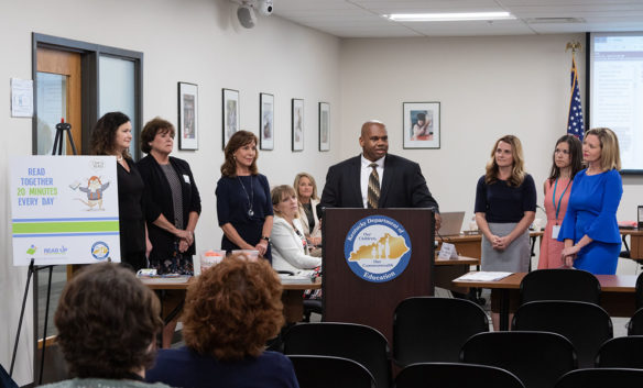 Kentucky Education Commissioner Wayne Lewis, center, announces a new summer reading and math initiative at the Kentucky Board of Education meeting June 5.
