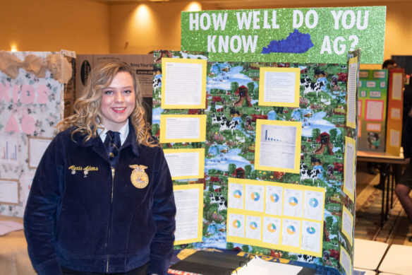 Alexis Adams from Mason County High School stands in front of her project for the Agriscience fair at the 2019 FFA State Convention Expo.