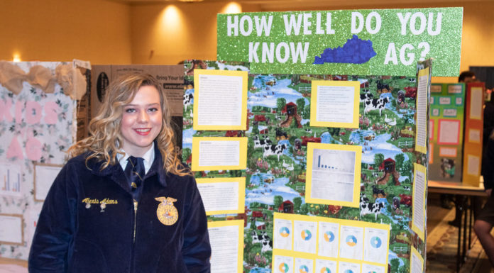 Alexis Adams from Mason County High School stands in front of her project for the Agriscience fair at the 2019 FFA State Convention Expo.
