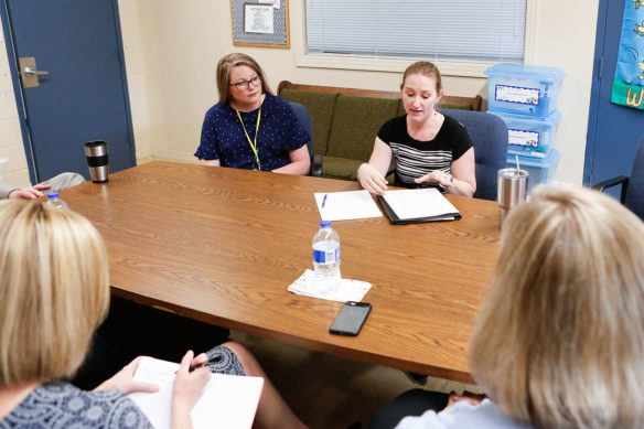 Christina Grant, an assistant professor at Murray State University, discusses the results of a research reading intervention project as Ashton Giles, a 4th-grade teacher at Fulton County Elementary School, looks on. Photo by Mike Marsee, April 23, 2019