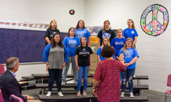 Kentucky Board of Education Chairman Hal Heiner, far left, listens as members of the Graves County Middle School choir sing for attendees of the Graves County Conversation with the Commissioner tour.