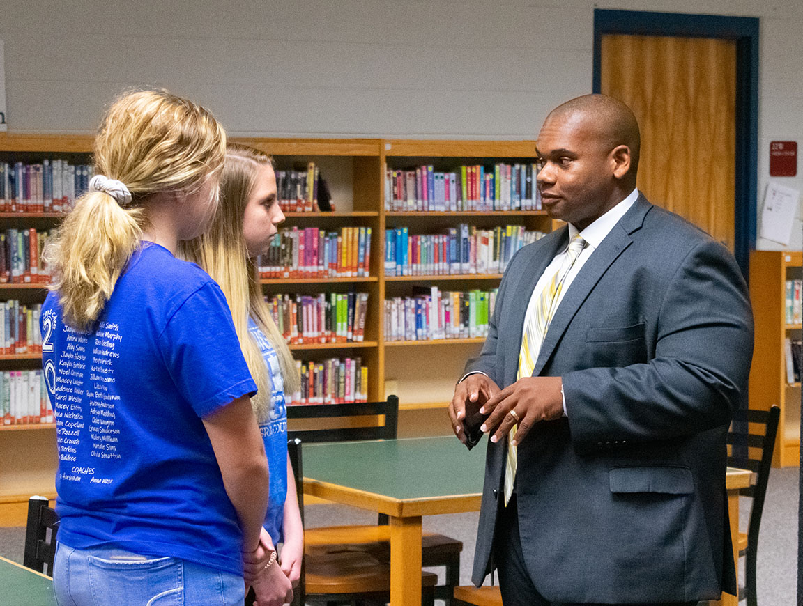 Education Commissioner Wayne Lewis speaks with two Graves County Middle School students during the Graves County Conversation with the Commissioner Tour.