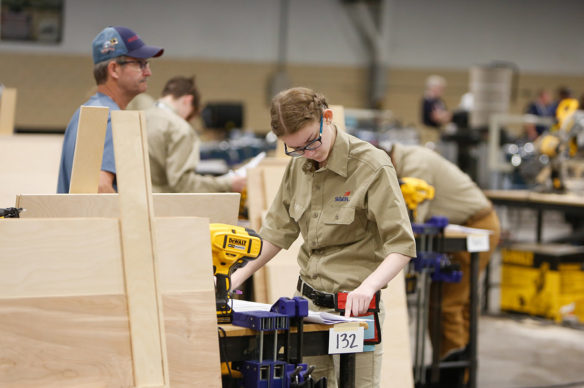 Christine Webb, a student at Monroe County Area Technology Center, reviews specifications and instructions for the cabinetmaking competition at the SkillsUSA Championships at the Kentucky Exposition Center in Louisville. Photo by Mike Marsee, June 26, 2019