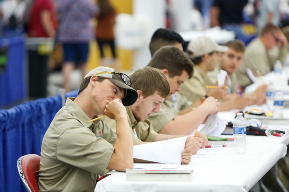 Braxston Trivett, a student at Monroe County Area Technology Center, flexes his neck as he begins a written exam that was part of the industrial motor control competition at the SkillsUSA Championships. Photo by Mike Marsee, June 26, 2019