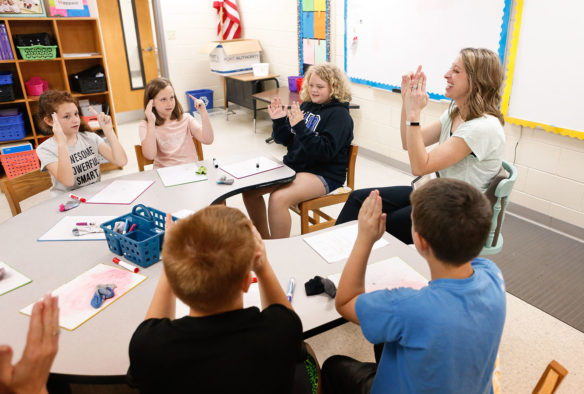 Monica Jones, a novice reduction coach at Oak Hill Elementary School (Pulaski County), works with a group of students at the school.