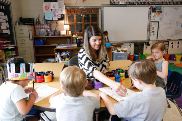 Kaity Woods, works with a group of students in her kindergarten classroom at Oak Hill Elementary School.