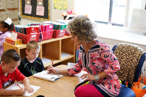 Becky Howard works with a group of students in her kindergarten classroom at Oak Hill Elementary School.
