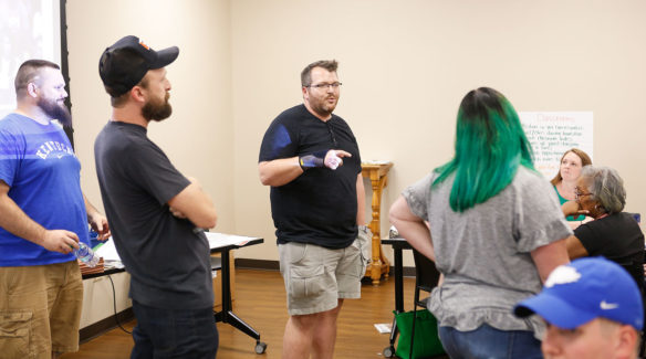 Willie Carver, center, a teacher at Montgomery County High School, takes part in an exercise during the Olweus bullying prevention coordinating committee training. Photo by Mike Marsee, Aug. 1, 2019