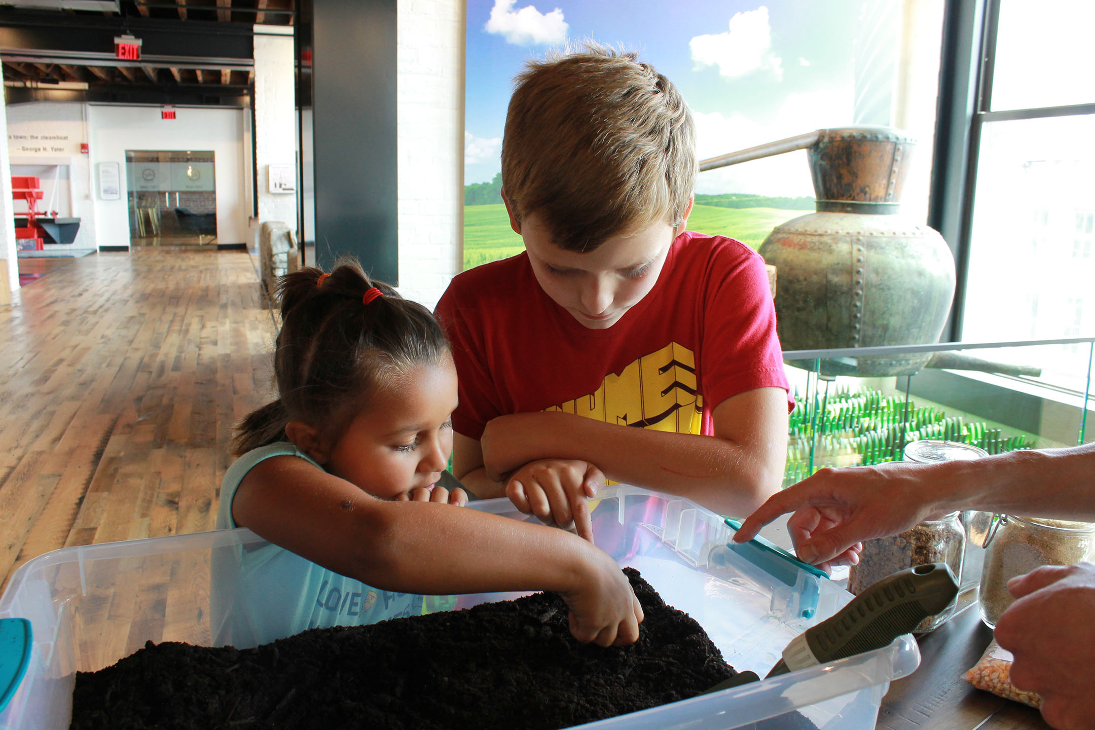 Students enjoy the hands-on soil cart in The Spirit of Kentucky® exhibit at the Frazier History Museum in Louisville.