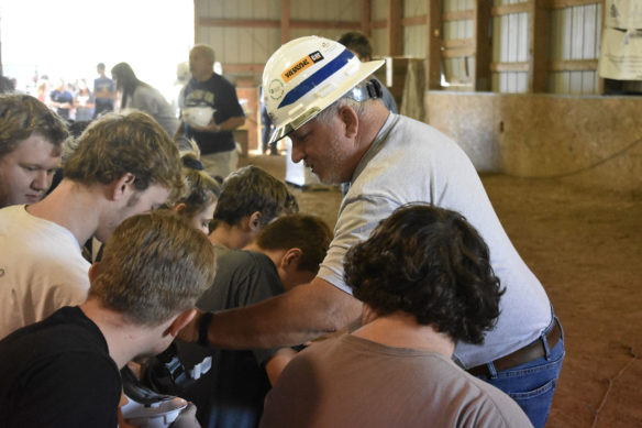 Ricky Cox from the Department of Juvenile Justice assists students with their hard hats.