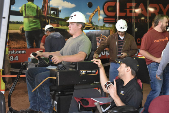 Colton Kessinger, from Spencer County High School, operates a driving simulator from CAT. 