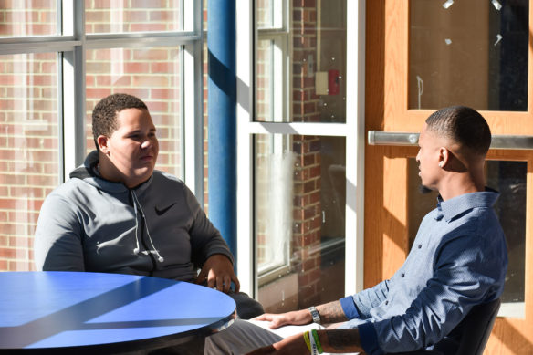 Former University of Kentucky basketball player and current Director of Campus Wellness at Kentucky State University Twany Beckham (right) speaks with his mentee Braelyn Taylor.