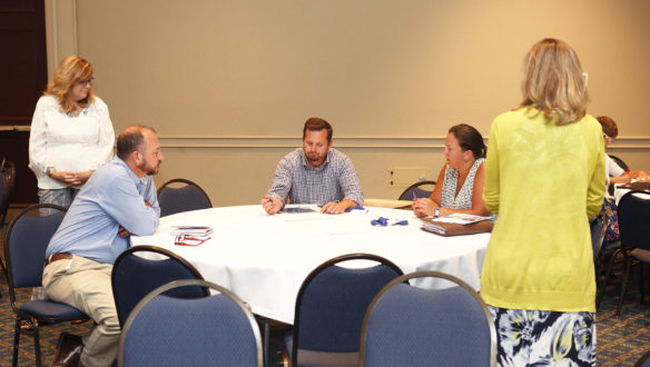 Kathy Maciel, left, and Lisa Loague, right, behavior consultants with the Green River Regional Educational Cooperative, discuss the Comprehensive School Threat Assessment Guidelines with educators at the Kentucky Department of Education’s Persistence to Graduation Summit in Lexington. Photo by Mike Marsee, July 10, 2019