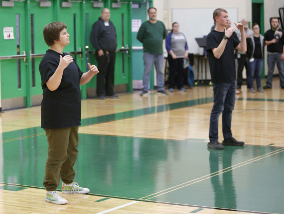 Kentucky School for the Deaf seniors Ben Shirley, left, and Jesse Rice sign the national anthem prior to the first game of the Mason-Dixon Tournament at KSD. Photo by Mike Marsee, Jan. 23, 2020
