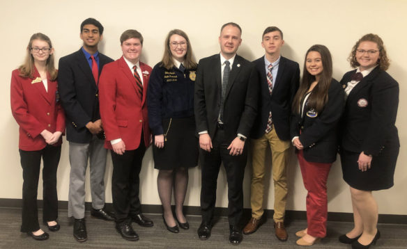 Interim Education Commissioner Kevin C. Brown, center, poses with the students after the recognition.