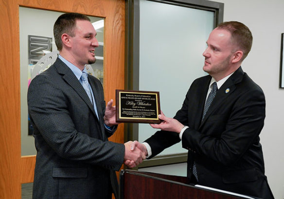 Kiley Whitaker, left, assistant director of the Division of Technical Schools and Continuous Improvement at the Kentucky Department of Education, receives the 2019 Kevin M. Noland-Mary Ann Miller Award from Interim Education Commissioner Kevin C. Brown.