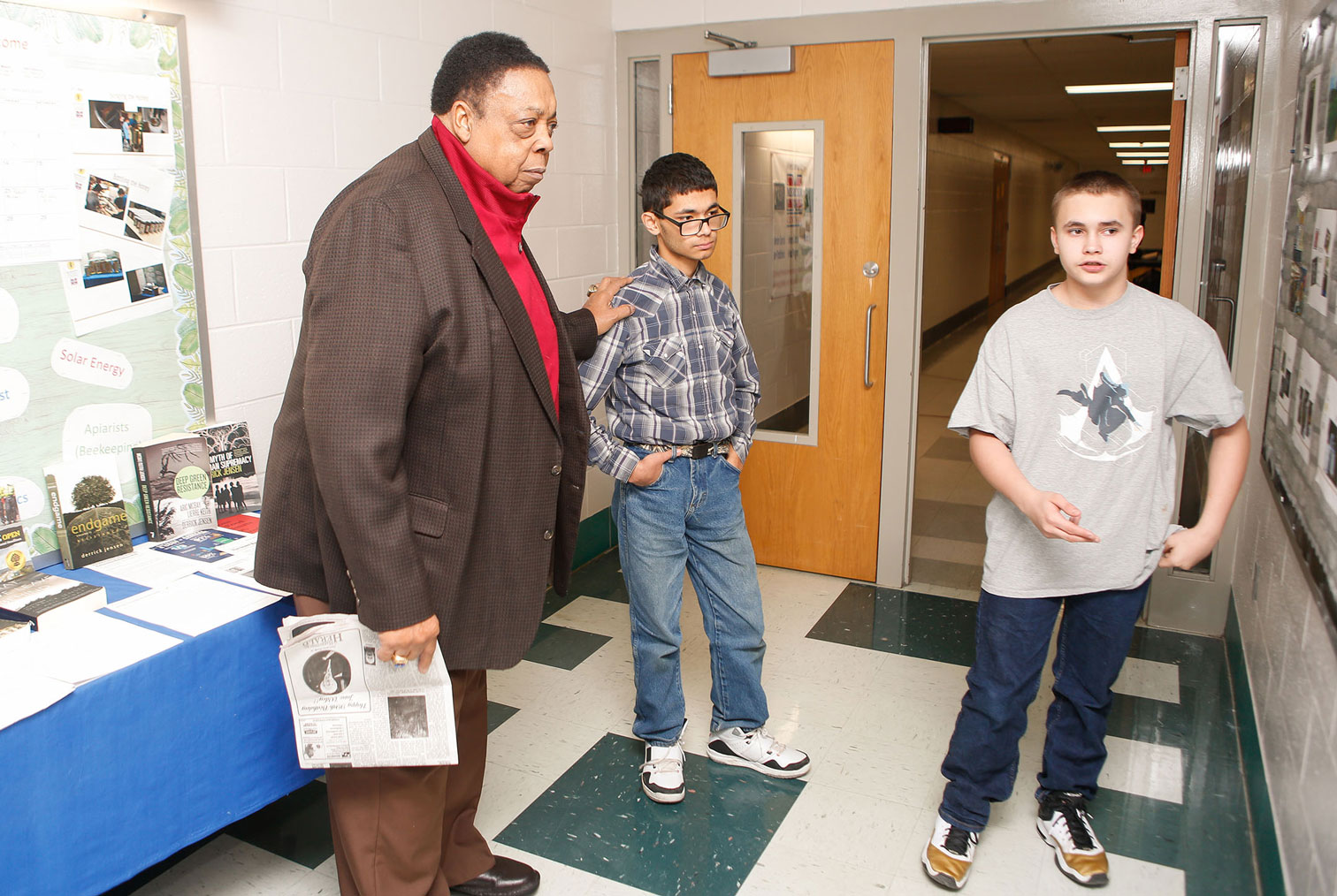 Alvis Johnson, left, a member of the Kentucky Board of Education, hears students in the Mercer County Day Treatment program discuss their beekeeping operation during a visit to the school