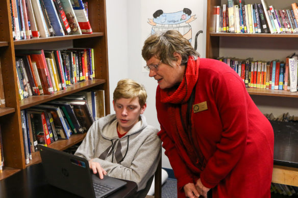 Frankfort High School freshman Jordan Thompson shows KBE member Claire Batt his work.