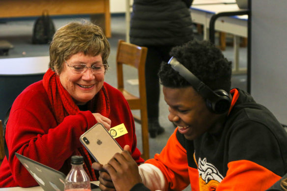 Kentucky Board of Education member Claire Batt speaks with Frankfort High School freshman Junior Carter about his school work.