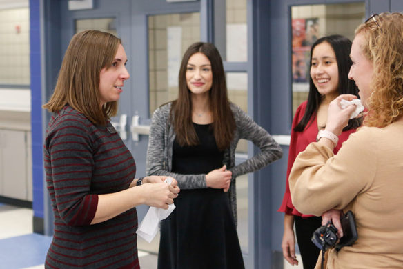 Laura Cole, left, a mathematics teacher at Scott High School (Kenton County), talks with students Bella Giordano, center, and Evelyn Hernandez and school counselor Jill Holthaus following a ceremony at which Cole was named a Milken Educator Award winner. Photo by Mike Marsee, Feb. 26, 2020