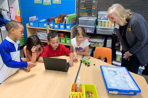 Students put their coding skills to work in a classroom at Jennings Creek Elementary School (Warren County) as Patrice McCrary, a member of the Kentucky Board of Education, looks on. 