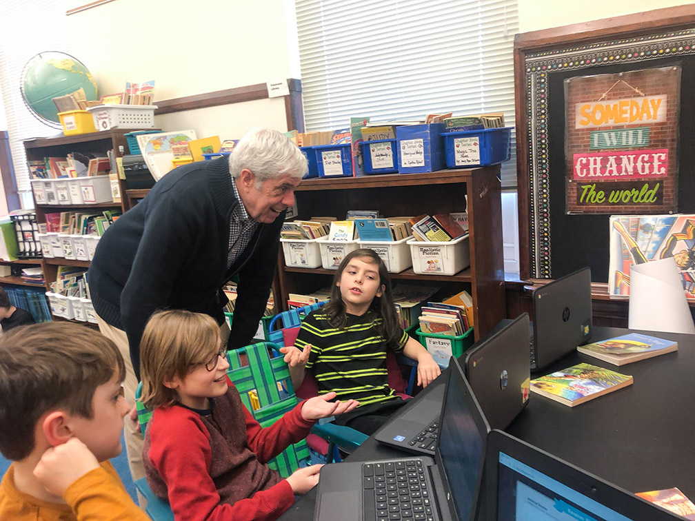 Kentucky Board of Education Chairman David Karem talks with Bloom Elementary School students about their technology projects during a February 2020 visit to the school.