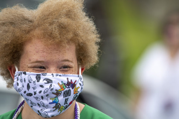 Kentucky School for the Deaf graduate Joanna New smiles underneath a mask during her graduation ceremony.