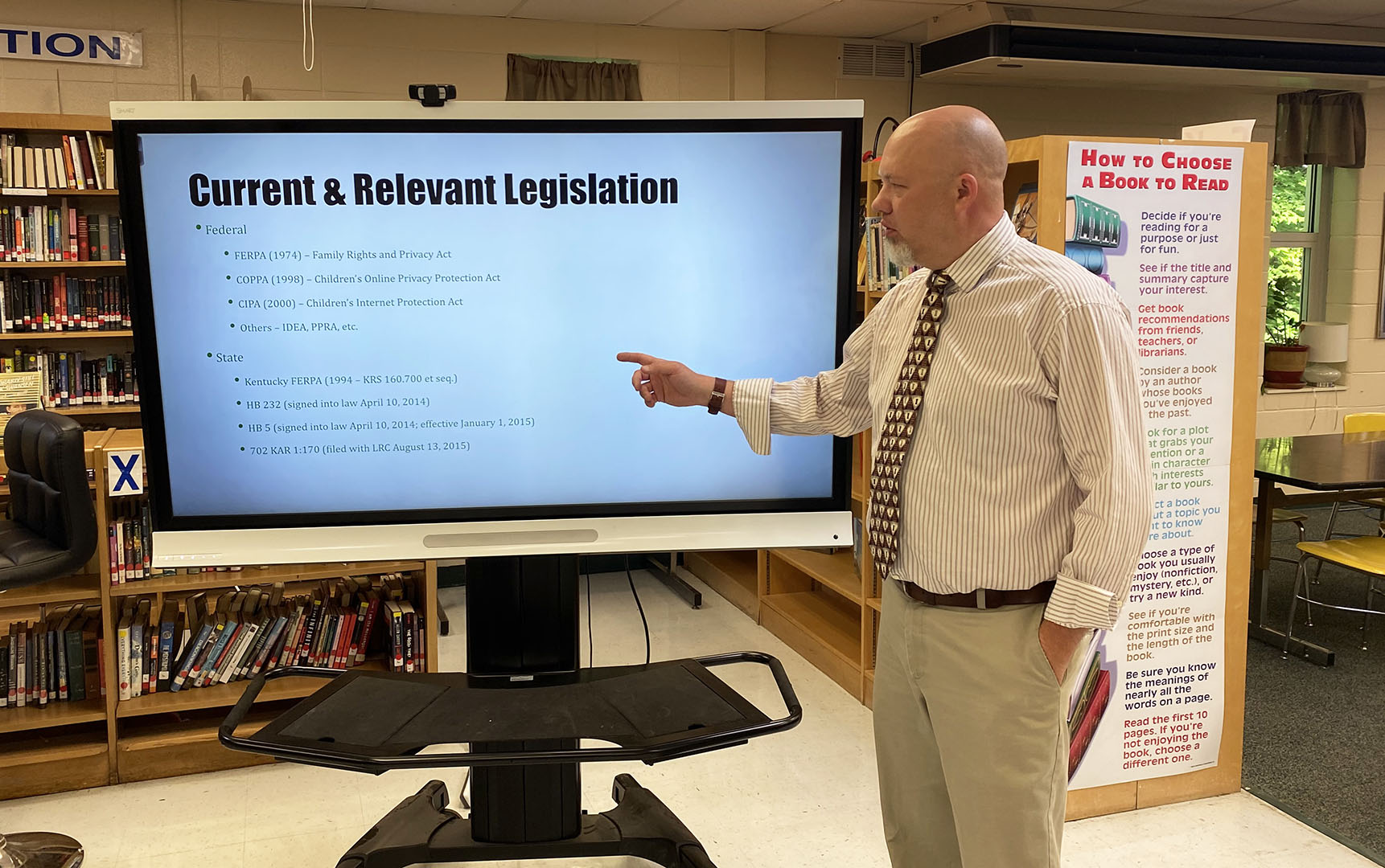 Damian Johnson gives a presentation on education legislation.