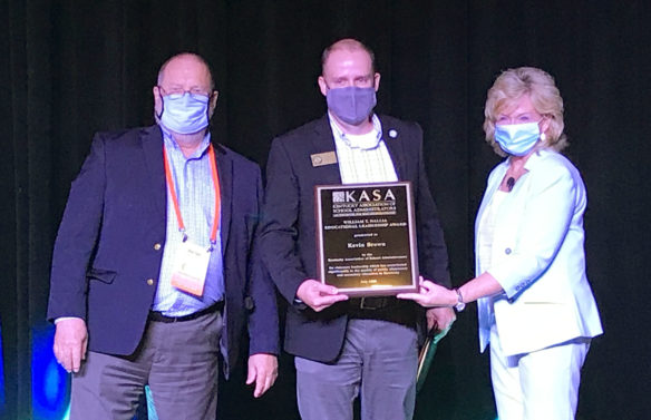 Interim Education Commissioner Kevin C. Brown, center, receives the 2020 William T. Nallia Award from the Kentucky Association of School Administrators (KASA).