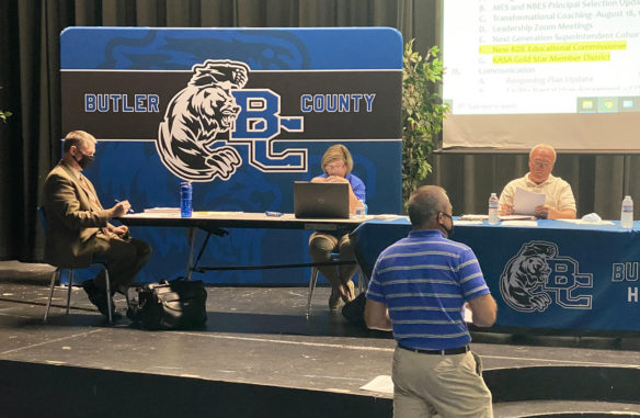 New Butler County Superintendent Robert Tuck, far left, works during a school board meeting July 14.