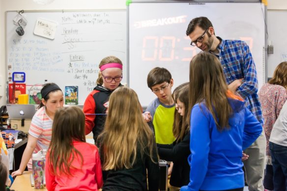 Donnie Piercey works with his students on a project in a classroom.