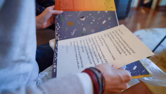 Close up of a letter being held by a woman.