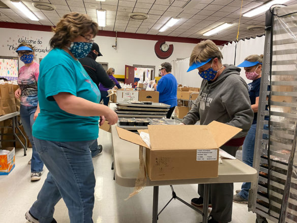 Harrison County food service workers preparing food for delivery.