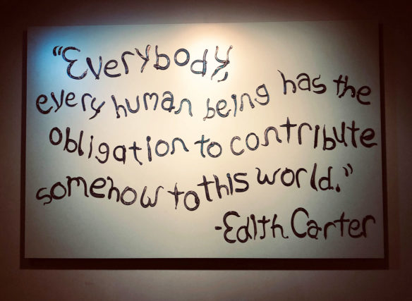 A sign reading: Everybody, every human being has the obligation to contribute somehow to this world. Edith Carter