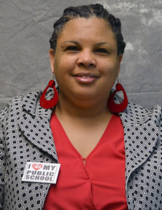 Picture of a smiling woman in a suit.