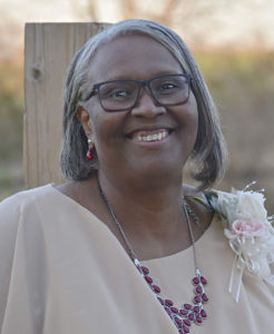 Picture of a smiling woman wearing glasses.